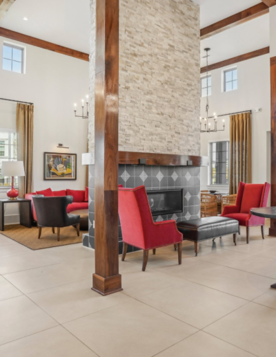 Living Room Area Featuring Stone Fireplace & Chairs