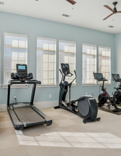 Gym Room Featuring Light Blue Walls & Large Windows